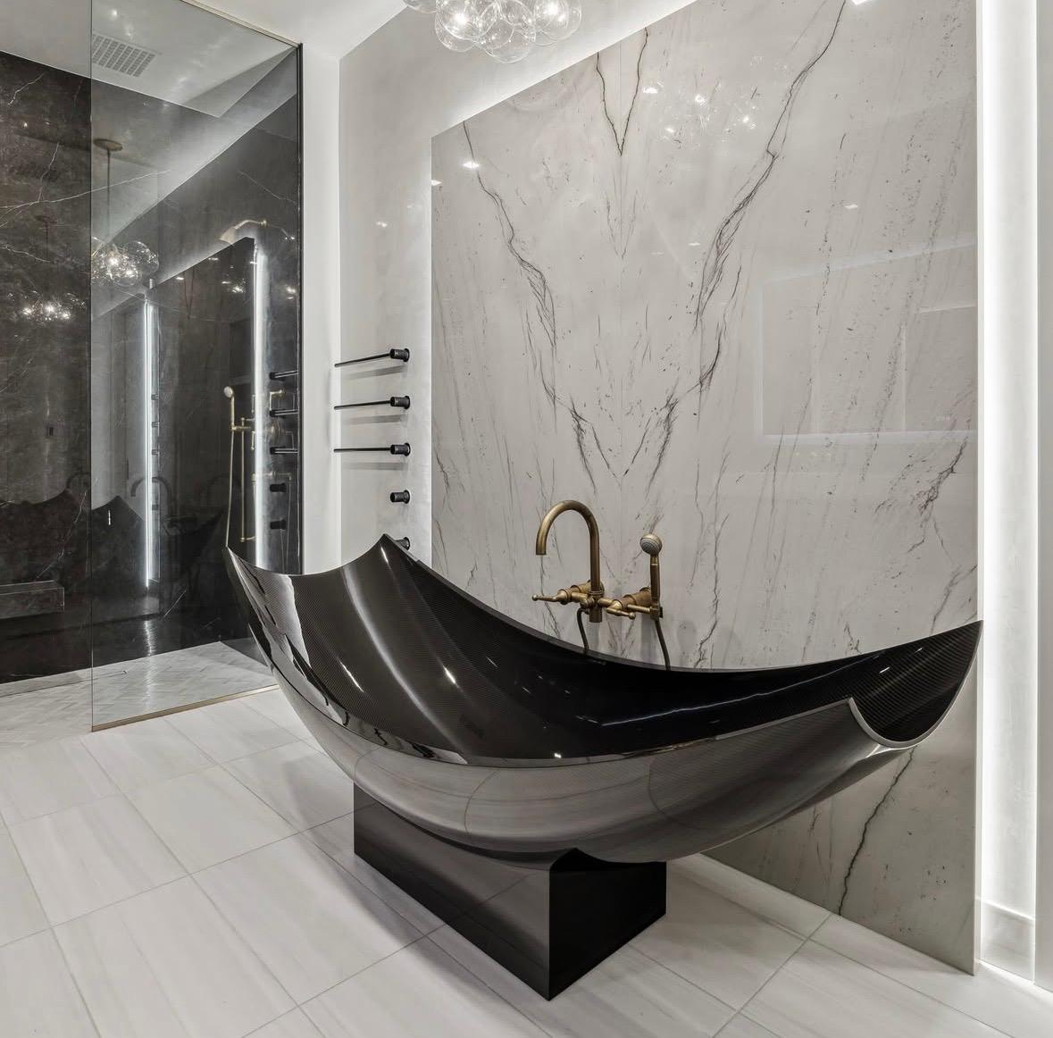 Black carbon bathtub with marble walls and brass fixtures, The Residences at The Allen