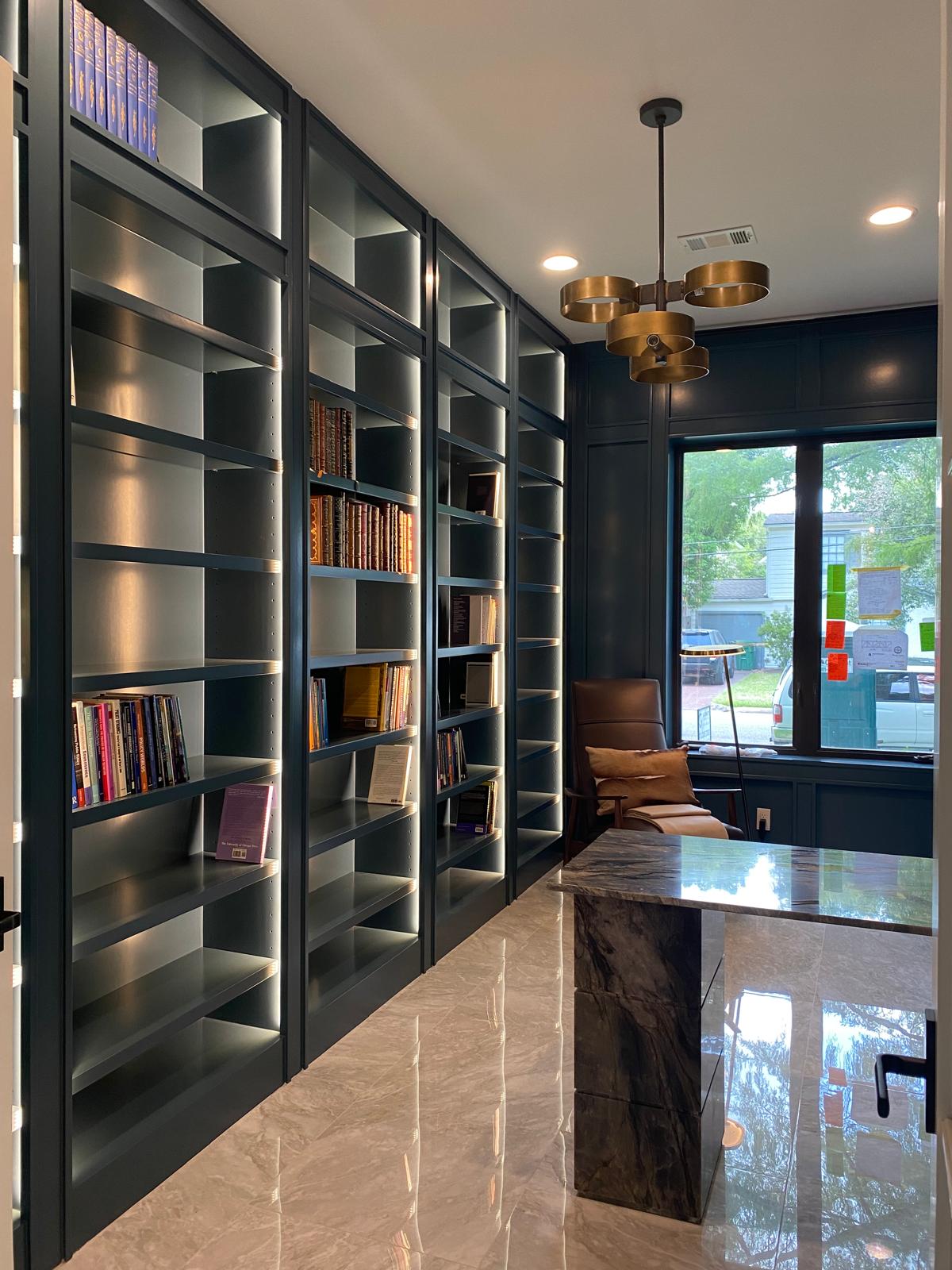 Library and home office with dark green built-in shelving and a brass ring chandelier, Montrose