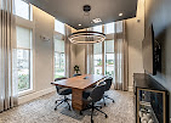 Meeting room with a conference table and tall windows, Alexan Lake Olympia